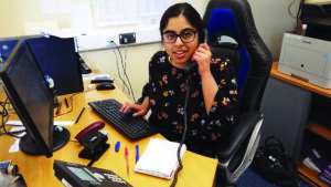 Student answering the phone at Derwen College Ludlow