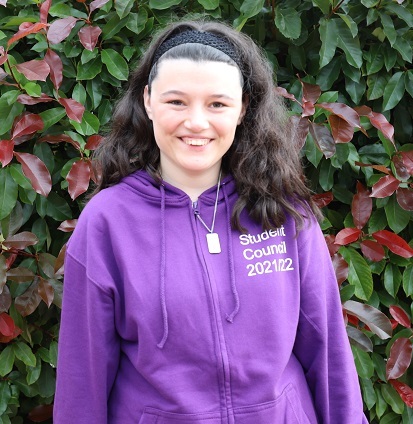 Amy, wearing a purple Student Council hoodie, and smiling