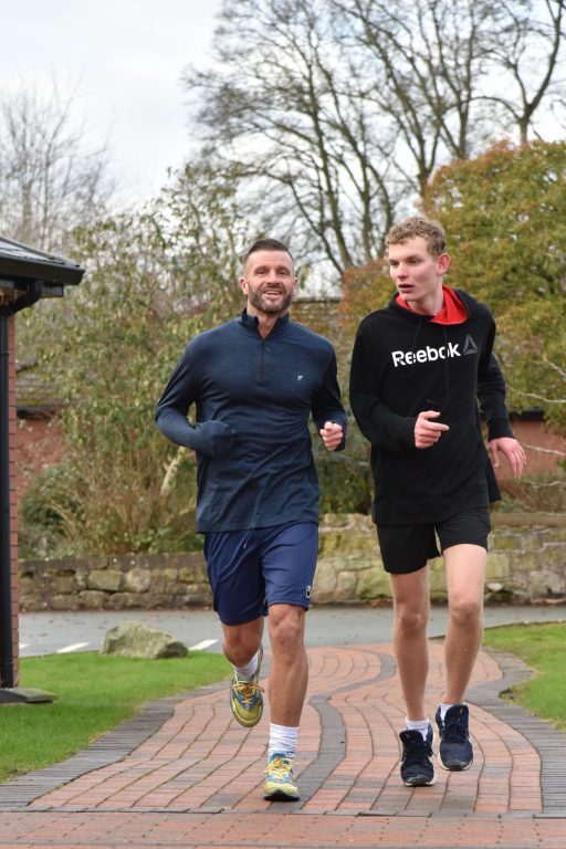 Staff and student running 